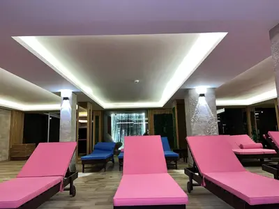 a waiting room with pink benches and blue chairs at Milmari N lux Sena in Kopaonik