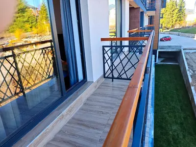 a balcony of a house with a wooden railing at Harmony, Residence Hill A85 in Kopaonik