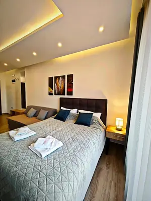 a bedroom with a bed with two towels on it at Harmony, Residence Hill A85 in Kopaonik