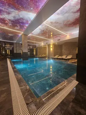 a swimming pool in a building with a star ceiling at Harmony, Residence Hill A85 in Kopaonik
