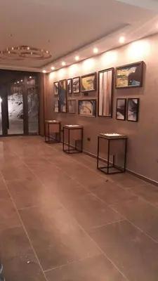 a room with two tables and pictures on the wall at Kopaonik-Residence Hill Repnica A71 in Cajetina