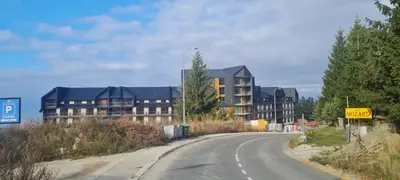 an empty road in front of a apartment complex at Kopaonik-Residence Hill Repnica A71 in Cajetina