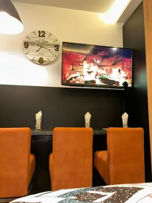 a dining room with three chairs and a clock on the wall at Kopaonik-Residence Hill Repnica A71 in Cajetina