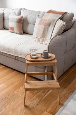a coffee table next to a grey couch with a coffee cup at Glečer Kop, Apartment A14, FREE Parking Garage in Kopaonik