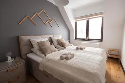 a bedroom with a large bed with towels on it at Glečer Kop, Apartment A14, FREE Parking Garage in Kopaonik