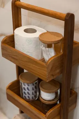 a shelf with a roll of toilet paper and dishes at Glečer Kop, Apartment A14, FREE Parking Garage in Kopaonik