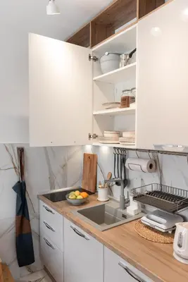 a kitchen with white cabinets and a sink at Glečer Kop, Apartment A14, FREE Parking Garage in Kopaonik