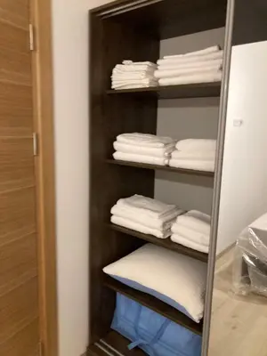 a closet filled with lots of white towels at Pogled Apartman Kopaonik in Kopaonik