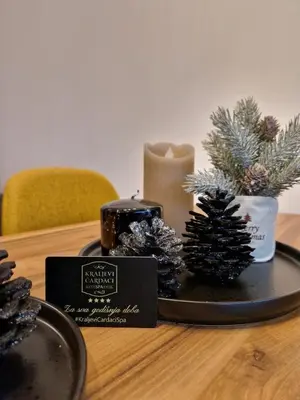 a tray with candles and pine trees on a table at Pogled Apartman Kopaonik in Kopaonik