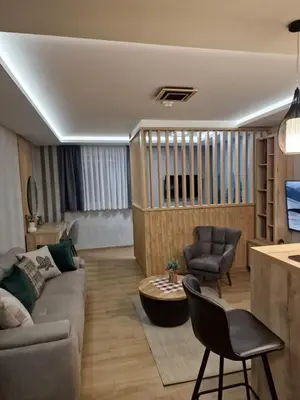 a living room with a couch and a table at Apartman 318 - Sunčana Planina in Kopaonik