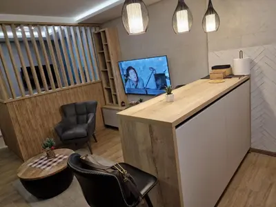 an office with a desk and a tv and a chair at Apartman 318 - Sunčana Planina in Kopaonik