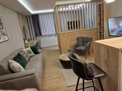 a living room with a couch and a table at Apartman 318 - Sunčana Planina in Kopaonik