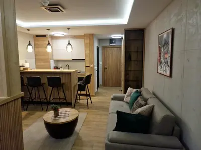 a living room with a couch and a table at Apartman 318 - Sunčana Planina in Kopaonik
