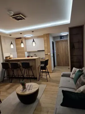a living room with a couch and a table at Apartman 318 - Sunčana Planina in Kopaonik