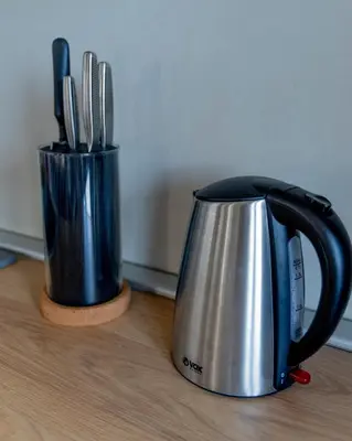 a black and silver coffee pot sitting on a table at Apartman Rustic 85m2 in Kopaonik