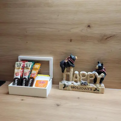 a box of holiday books with a figurine next to it at PIK Apartmani - Milmari in Kopaonik