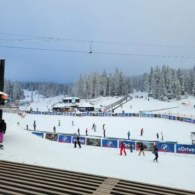 a group of people skiing down a snow covered slope at PIK Apartmani - Milmari in Kopaonik