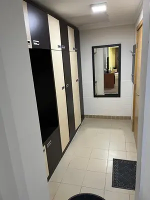 a bathroom with black and white cabinets and a mirror at Kop apartman I01 in Kopaonik