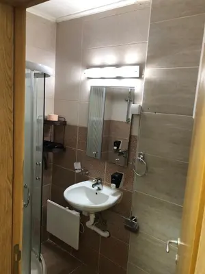 a bathroom with a sink and a mirror at Kop apartman I01 in Kopaonik