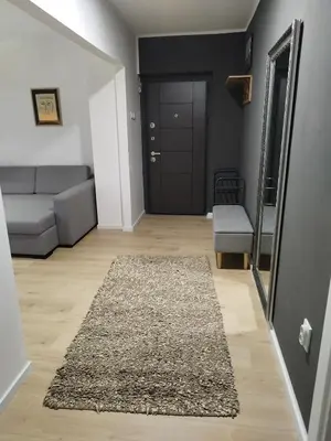 a living room with a couch and a mirror at Home apartment in Niš