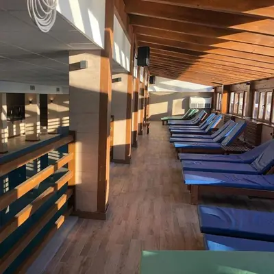 a row of blue lounge chairs in a building at Apartman Adut Kop. in Kopaonik