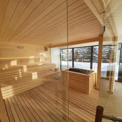 a large room with a sauna with a glass wall at Sunčani breg resort & spa in Kopaonik