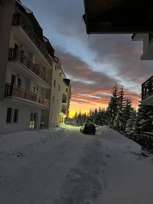 a car parked in the snow in front of a building at Studio M in Kopaonik