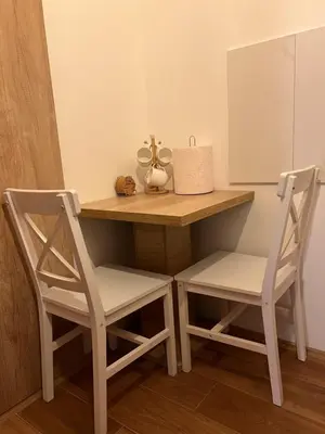 a desk with two chairs and a table with a mirror at Studio M in Kopaonik