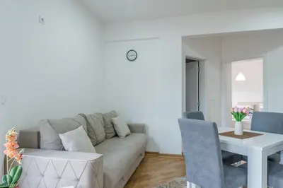 a living room with a couch and a table at Apartmani Central 11 & Free parking in Vrnjačka Banja