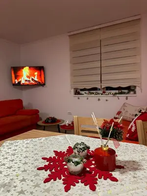 a living room with a table with red decorations on it at Silver Pine Kopaonik in Kopaonik