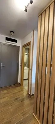 a room with a hallway with a door and wooden floors at Apartman Jovanovic,Kopaonik in Kopaonik
