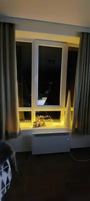 a window with christmas lights in a room at Apartman Jovanovic,Kopaonik in Kopaonik