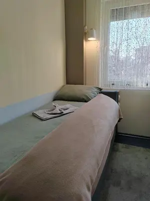 a bedroom with two beds and a window at Apartman Stanimirović 3 in Zaječar