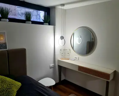a bedroom with a mirror and a bed at Drop Kop in Brzeće