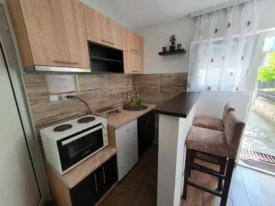 a small kitchen with a sink and a stove at Smeštaj Miki 2 in Soko Banja
