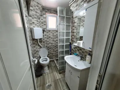a small bathroom with a toilet and a sink at Smeštaj Miki 2 in Soko Banja