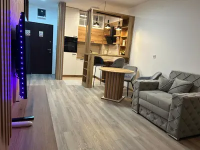 a living room with a couch and a table at De Lux Nedeljkovic President in Jagodina