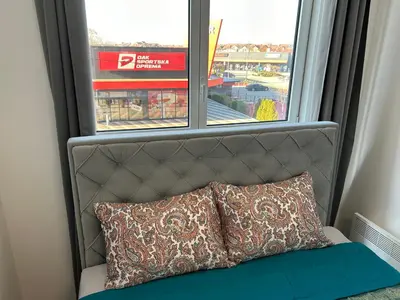 a window with a pillow sitting in front of it at De Lux Nedeljkovic President in Jagodina