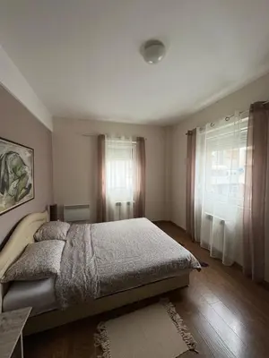 a bedroom with a bed and a window at Central Apartments in Zaječar