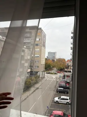 a view from a window of a parking lot with cars at Central Apartments in Zaječar
