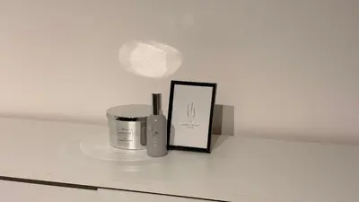 a shelf with a candle and a picture and a lamp at Central Apartments in Zaječar