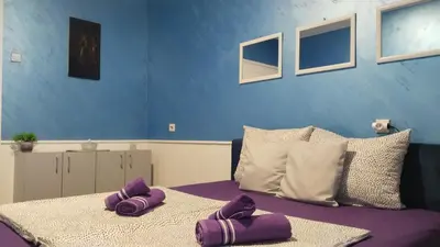 two purple towels sitting on a table in a room at Lela's home (Lelin dom) in Knjazevac.