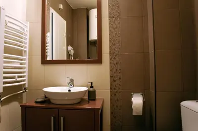 a bathroom with a sink and a mirror at La Maison in Niš