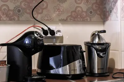 a toaster and a tea kettle on a kitchen counter at La Maison in Niš