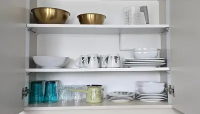 a cupboard filled with dishes and bowls and plates at Anikaapartmani, Brzeće in Brzeće