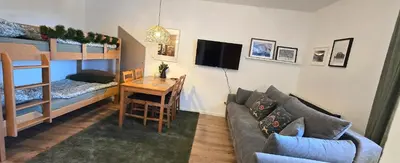 a living room with a couch and a table and a bed at Anikaapartmani, Brzeće in Brzeće