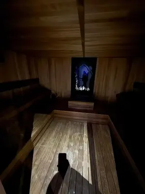 a room with a tv and a wooden floor at King apartments Kopaonik in Kopaonik