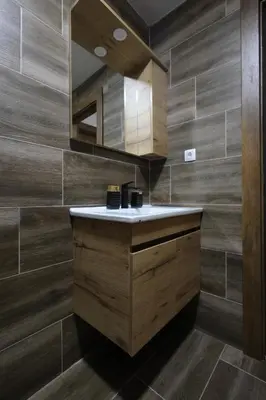 a bathroom with a sink and a mirror at King apartments Kopaonik in Kopaonik
