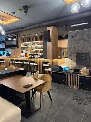 a restaurant with tables and chairs and a counter at King apartments Kopaonik in Kopaonik