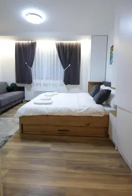 a bedroom with a large bed in front of a window at King apartments Kopaonik in Kopaonik